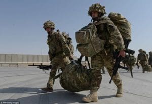 blog picture of two soldiers carrying equipment between them along with their own back packs