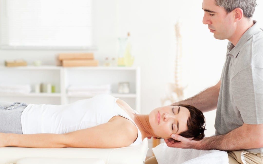blog picture of lady on massage table getting neck adjusted by chiropractor