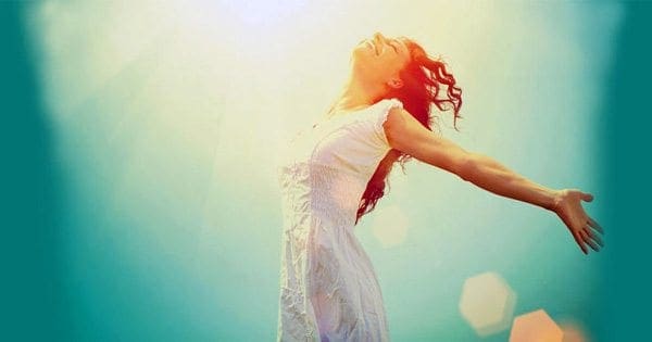 blog foto di signora che corre con le braccia spalancate sorridente al sole