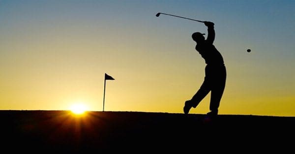 blog picture of golfer playing at sunrise